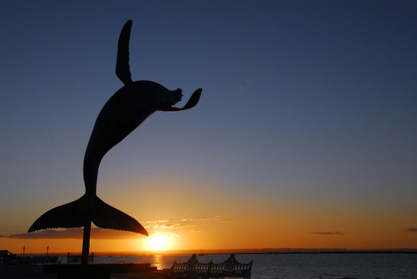 Breaching whale sculture at sunset, La Paz