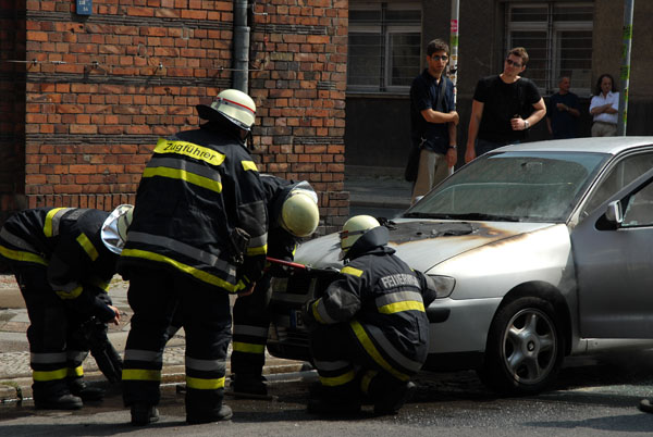 Berlin firefighters extinguish a car fire
