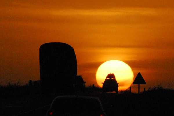 Car silhouetted against the rising sun...they stopped for this one