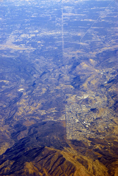 The US-Mexico border clearly visible at Tecate, Mexico