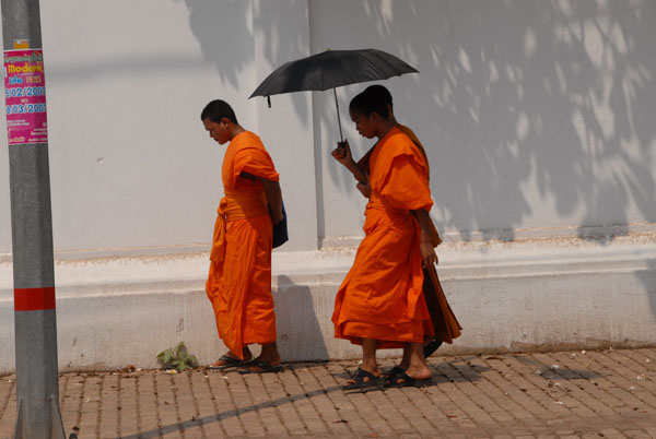 Monks with an umbrella in Vientiane