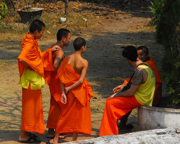 Lao monks talking with a westerner who seems to be a monk as well