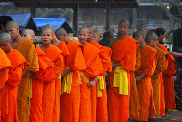Monks lined up in front of Luang Prabang school - too many tourists here