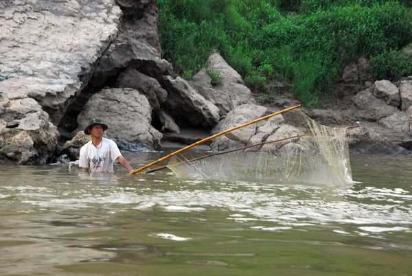A fisherman with a giant net, Mekong River, Laos