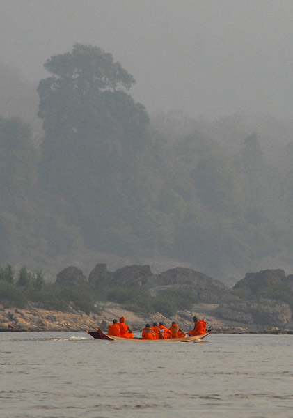 Monks in a boat heading upstream
