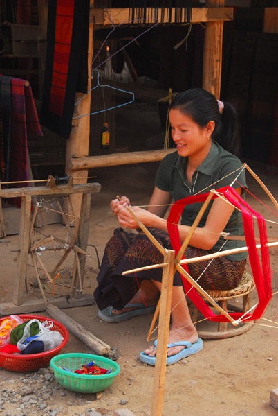 Lao woman with a spinning wheel, Ban Xang Hai