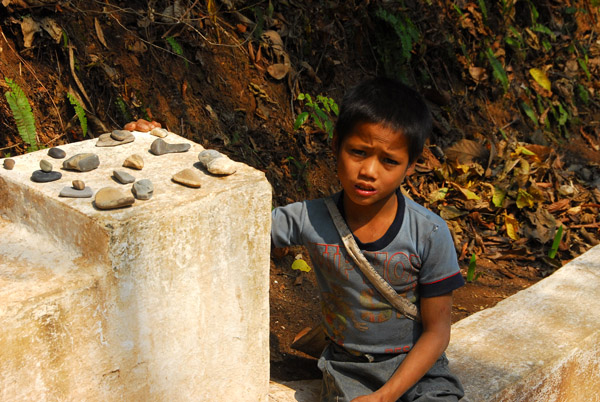 Poor village children try and sell rocks to tourists
