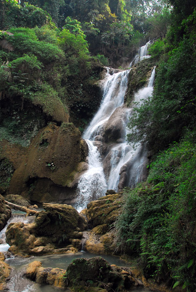 A steep trail leads up to additional falls