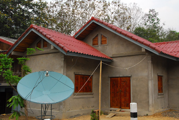 Satellite dish and new house, Ban Thapene