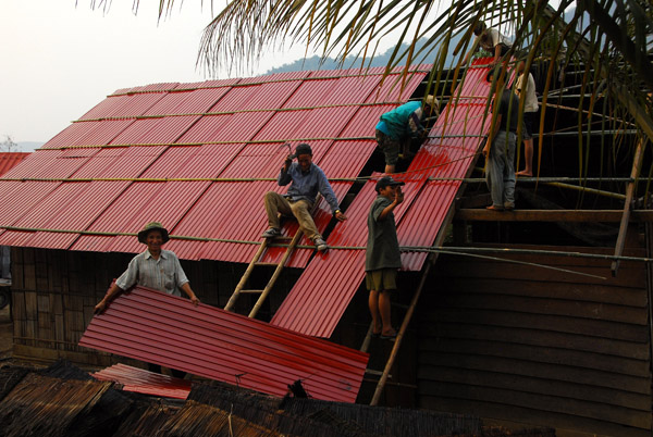 Mong men building a tin roof