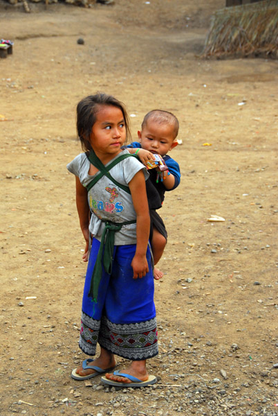 Young girl carrying a baby