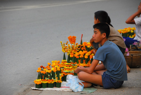 Boy selling flowers for temple offerings, Thanon Kitsalat, near the night market