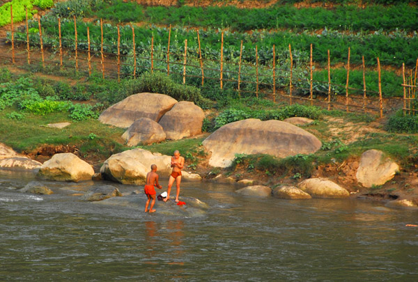 Monks playing in the river