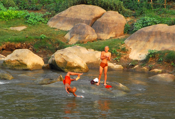 Monk performs a backflip off a rock, Nam Khan River