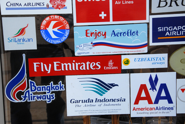 Airline stickers on a travel agency in Vientiane - Fly Emirates