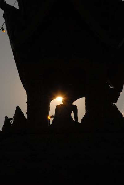 Late afternoon sun and the Buddha on the gateway near Pha That Luang