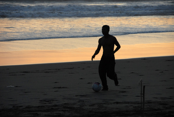 Balinese guys playing soccer around sunset, Seminyak Beach