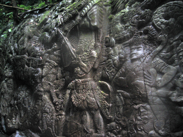 Balinese figures carved into the stone along the river below one of the resorts