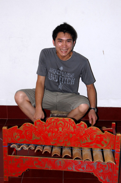 Jeng playing a traditional Balinese musical instrument