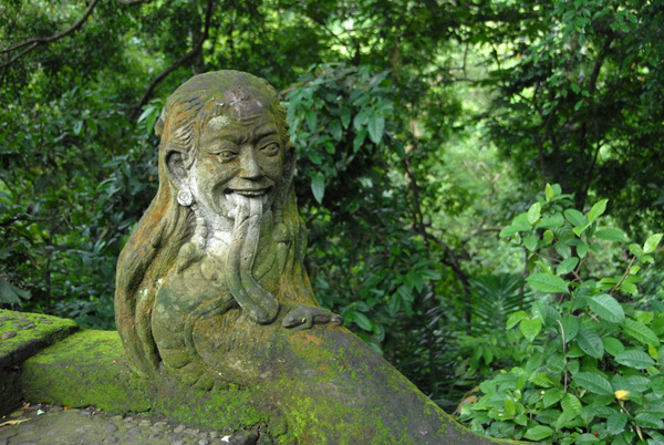 Old moss covered man along a banister, Sacred Monkey Forest