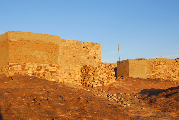 The morning sun illuminates the stone houses in Daga