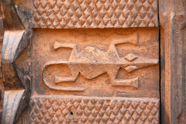 Detail of a carved door in the shape of a crocodile