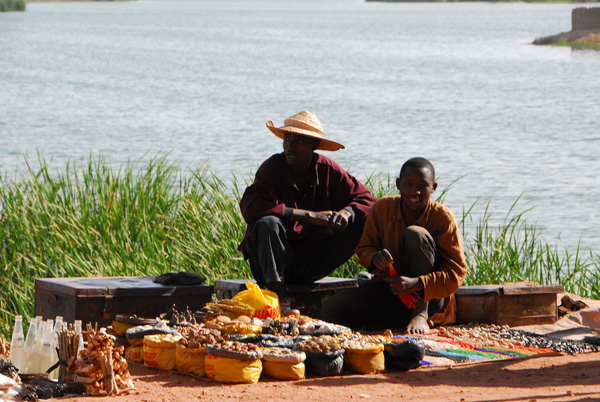 Men selling traditional medicines on the causeway to the Old Town district of Komoguel