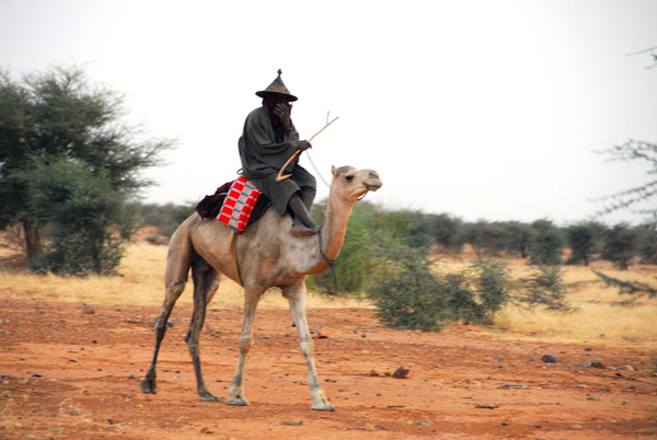 The next morning, a man on a camel passes our campsite