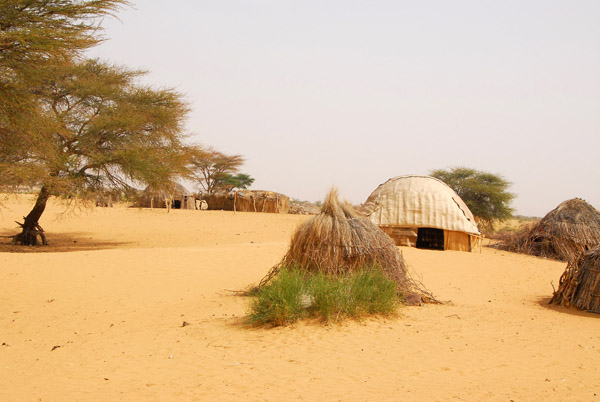 A tiny village of primitive huts along the track to Timbuktu, Mali