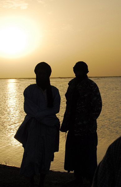 Silouettes of men by the Niger River