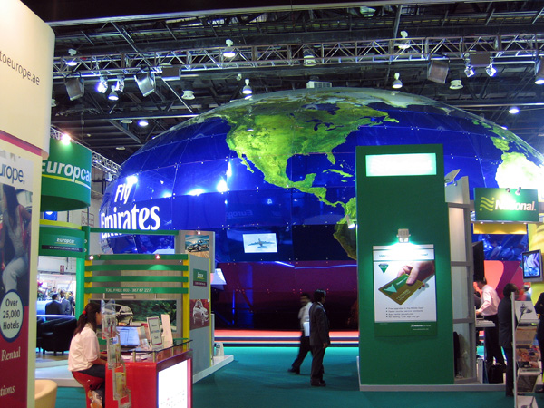 The giant globe of the Emirates Airline booth dominates the hall