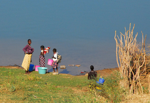 Woman and girls collecting buckets of water from the Sngal River, Mali