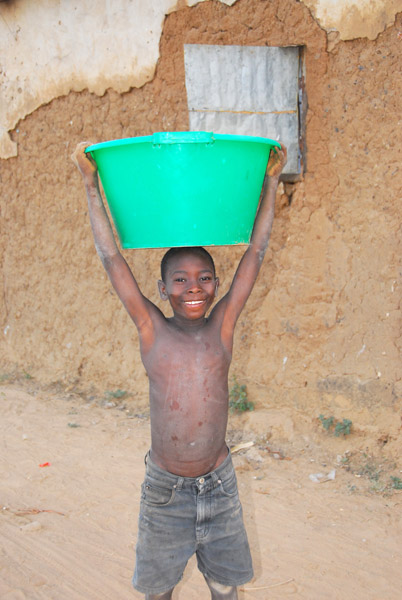 Boy holding a big green bucket