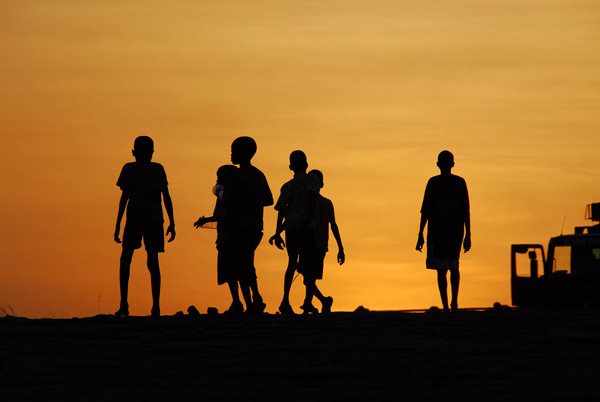 Silhouette of boys leaving our campsite at Chutes de Félou, Mali