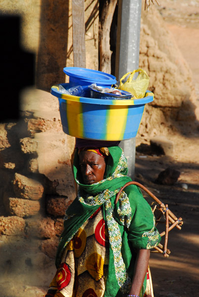 Woman carrying a bucket on her head, Bla, Mali