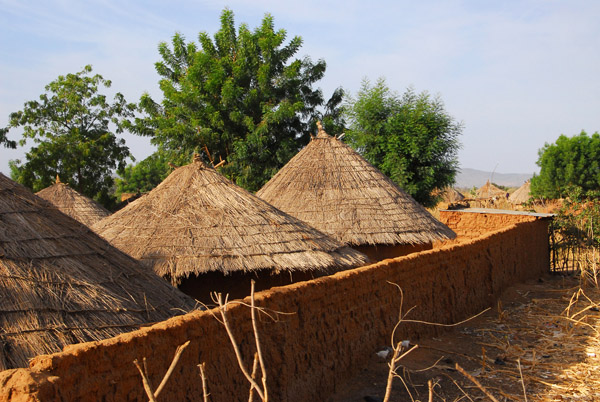 Walled compound with 3 thatched huts