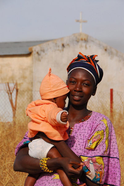 Woman and baby in front of the village church