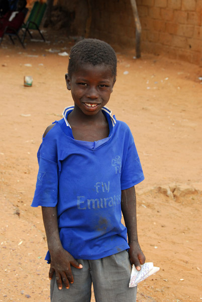 Boy in a faded Fly Emirates shirt, Diamou