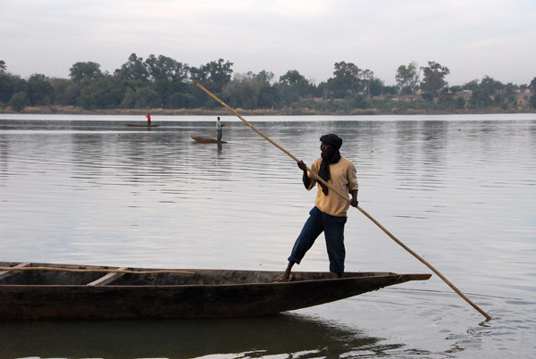 One of the village men poling his pirogue away from shore