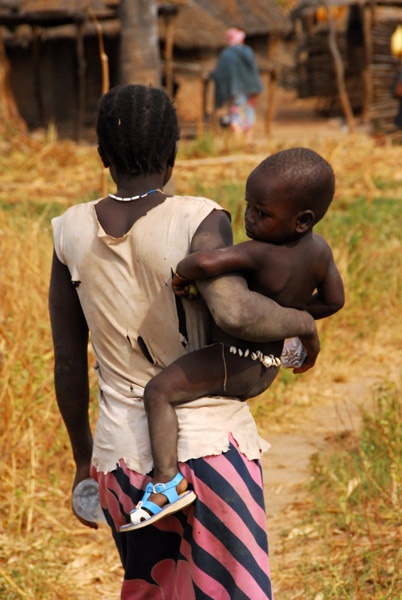 Woman carrying a kid on her hip
