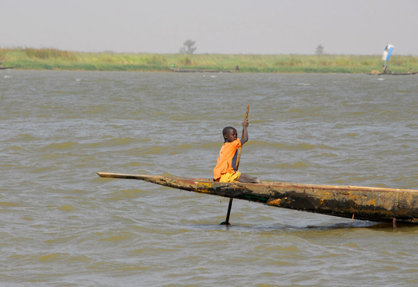 Young boy steering the pirogue, Niger River, Mali