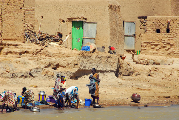 Girls washing dishes in the Niger River, Mali