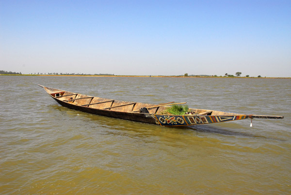 His pirogue is anchored nearby