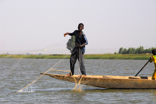 Boy fishing in the Niger River with nets, Kotaka