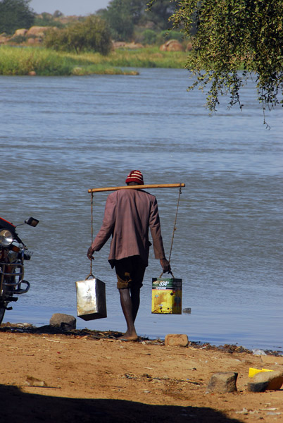 Man going to the river to fetch water