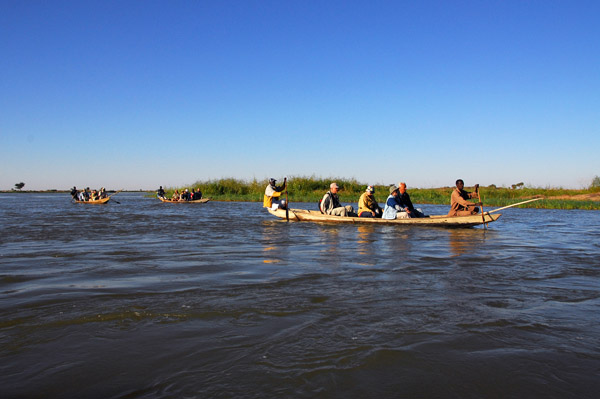 Our little flotilla heading down the Niger River