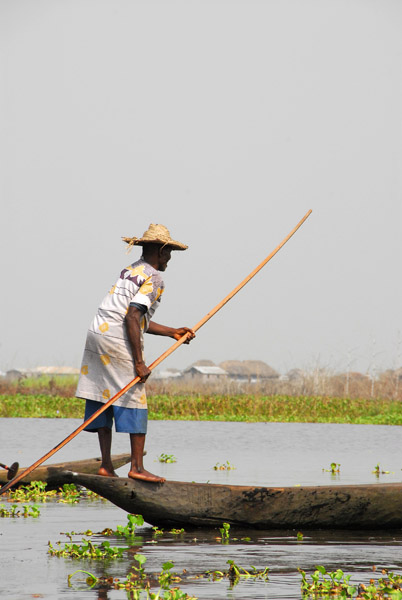 Man poling a canue, Lac Nakoué, Benin