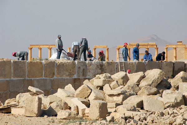 Workers restoring a section of the defensive wall of the Ancient City of Palmyra