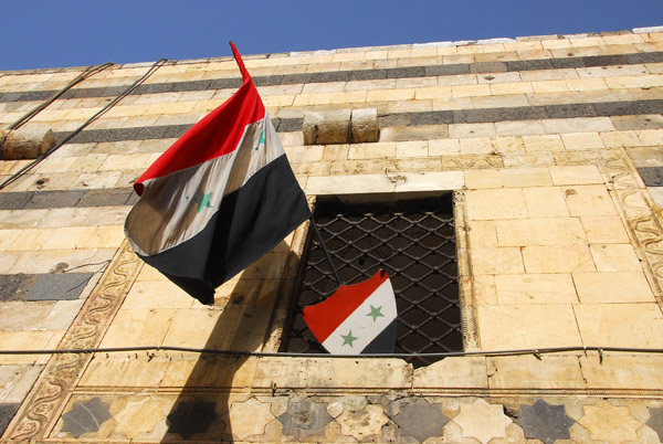 Syrian flags flying from Azem Palace