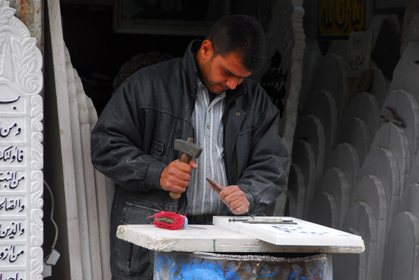 Syrian stone carver at work on a marble tablet